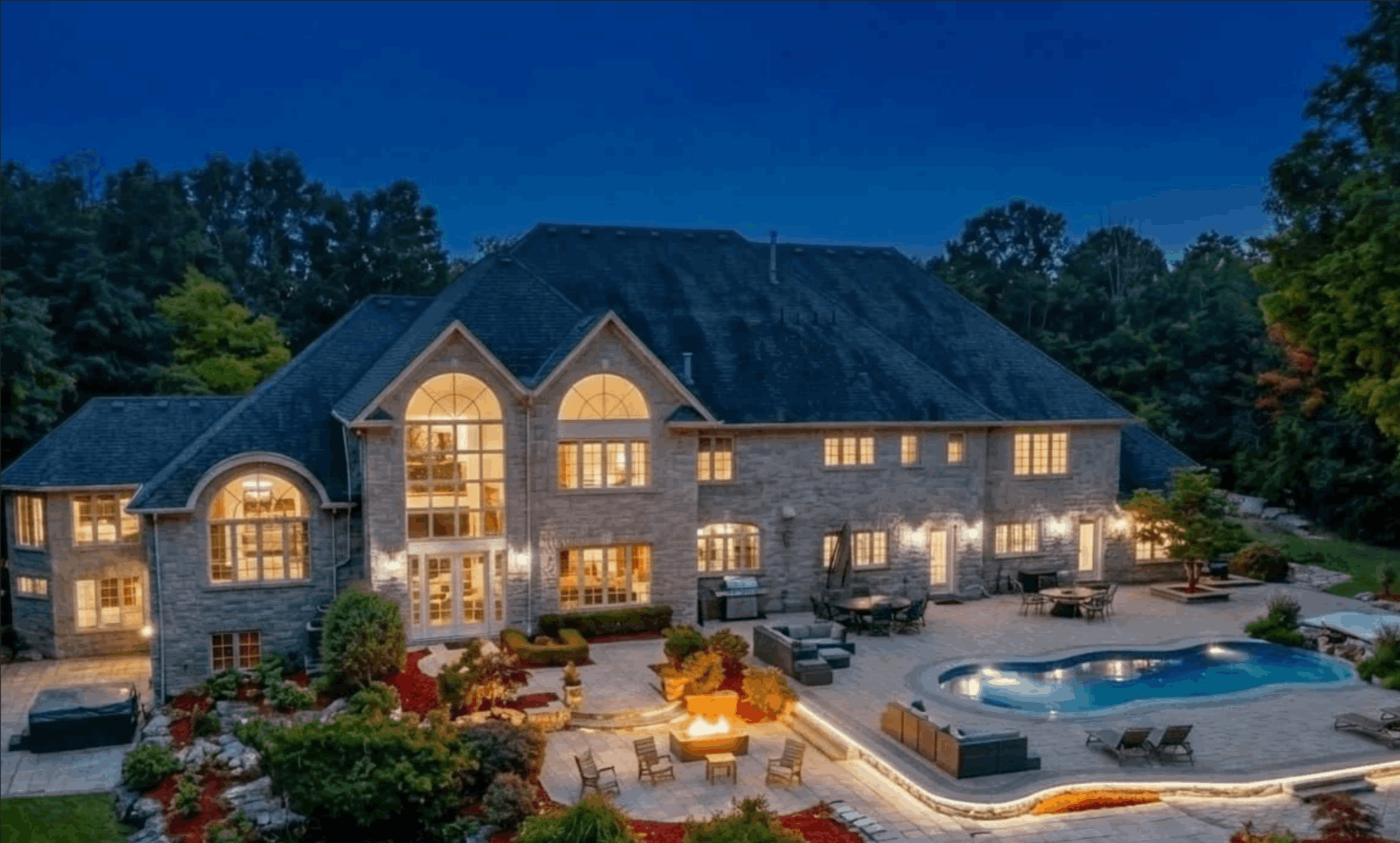 Luxury backyard with pool at night in Bayview Southeast Aurora Ontario