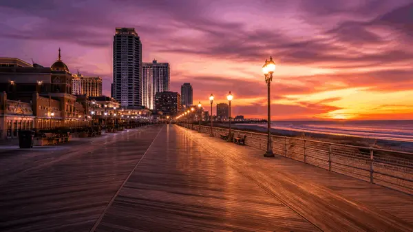 Atlantic City NJ boardwalk and skyline at dusk — AC real estate by Justus Rosario