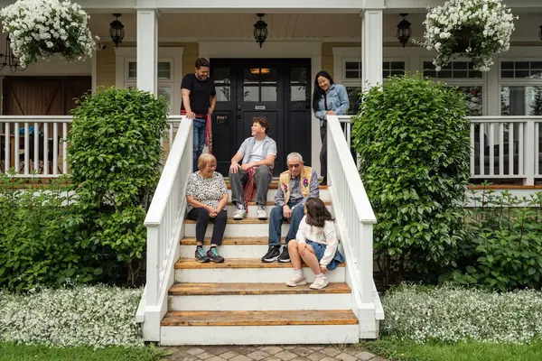 Family relaxing on the front porch of a home in the Greenville, South Carolina area