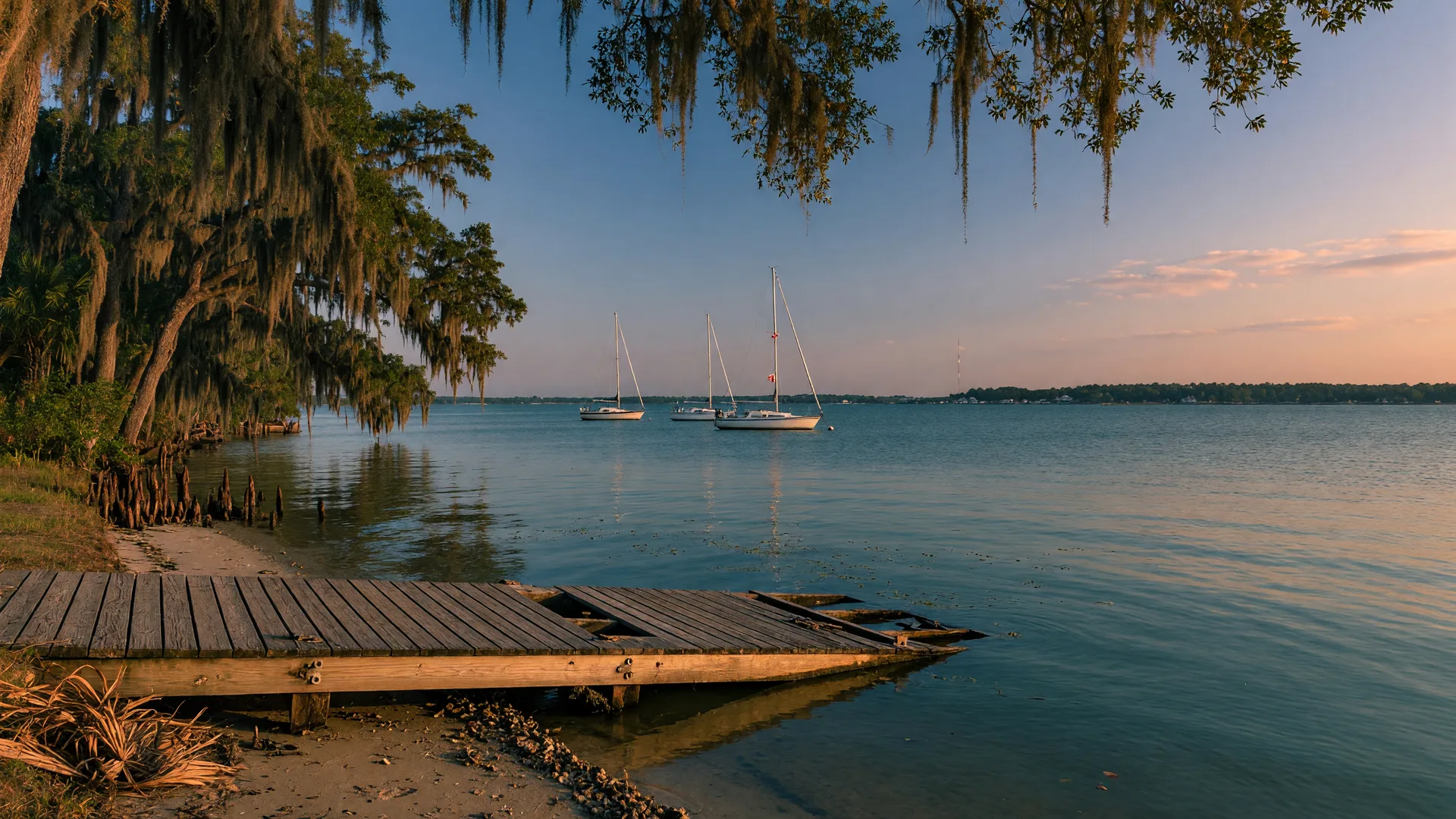 Mobile Bay shoreline at Spanish Fort Alabama with a boat ramp and Spanish moss oaks