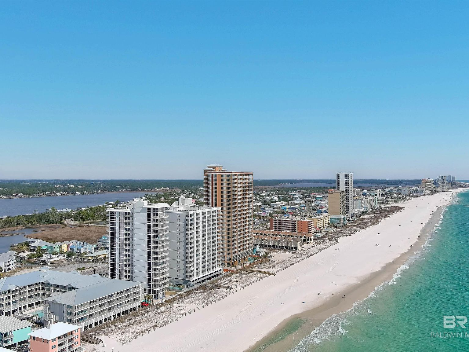 Aerial view of the Alabama Gulf Coast showing the coastline, beaches, and coastal communities near Orange Beach