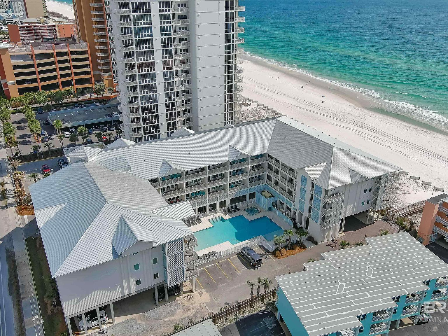 Drone aerial view of the Gulf Shores Alabama coastline with white sand beaches stretching along turquoise Gulf water