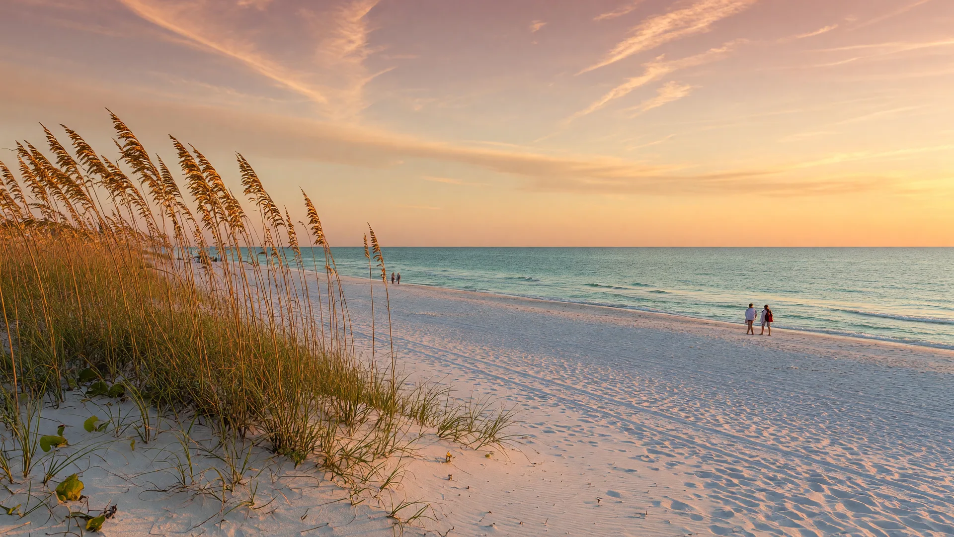 Golden-hour late September evening on an Alabama Gulf Coast beach with white sand, sea oats, and calm turquoise water