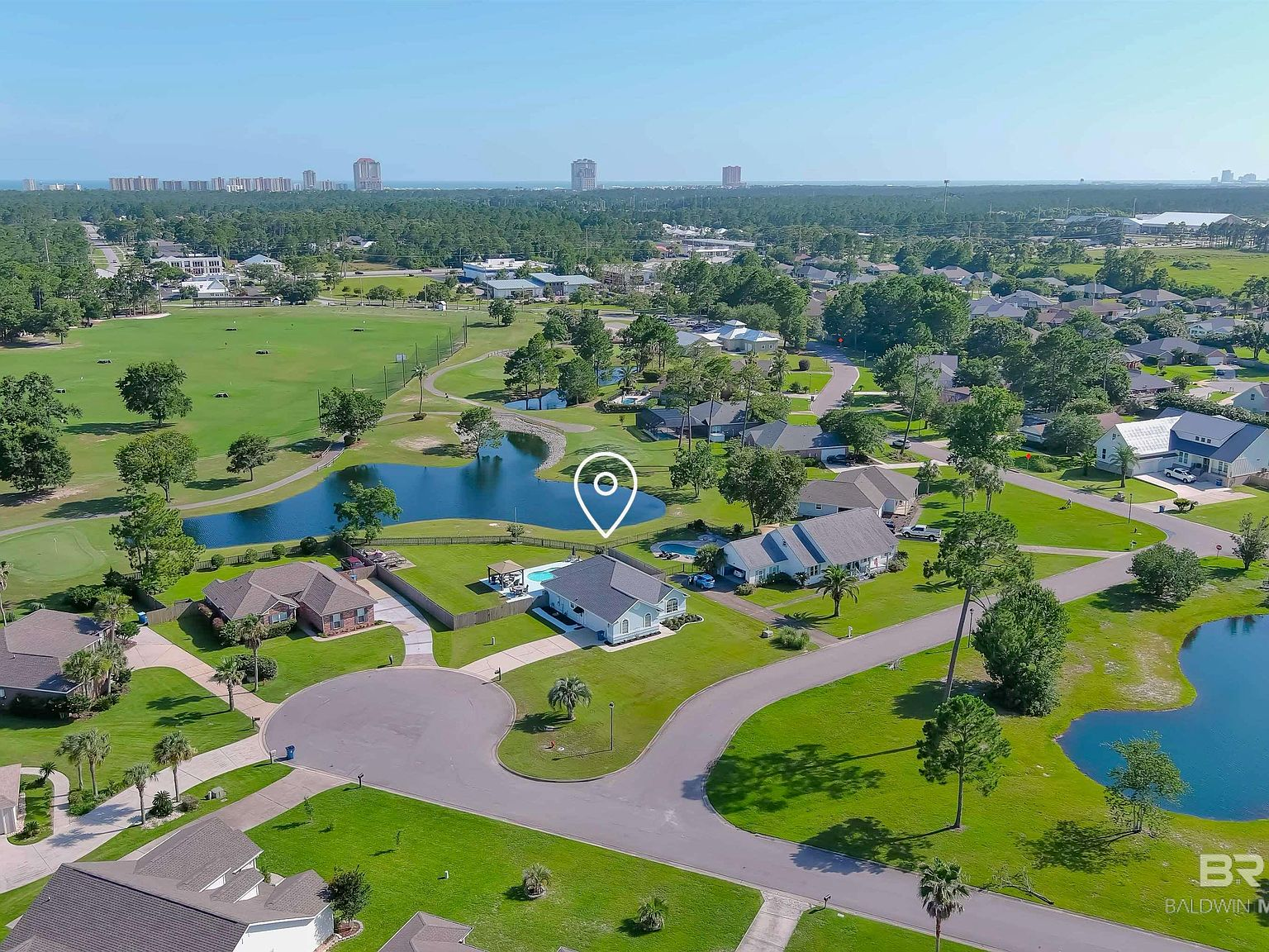 Drone aerial view of property, pool, and golf course fairway