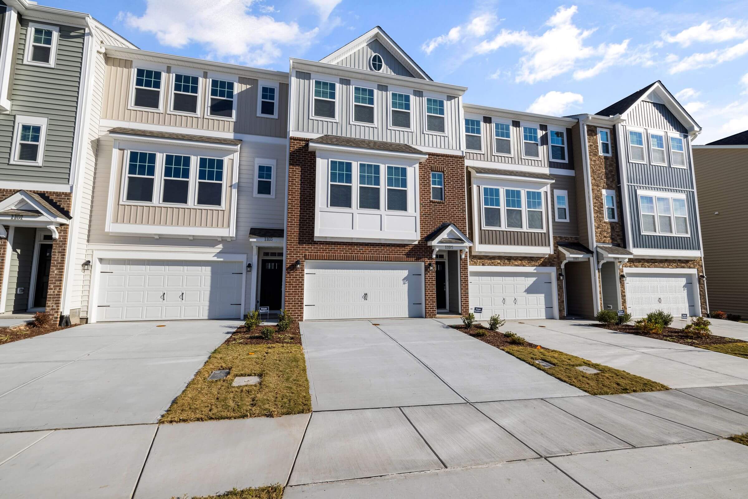 Row of modern multi-unit townhomes representing investment and income property services in Brant County