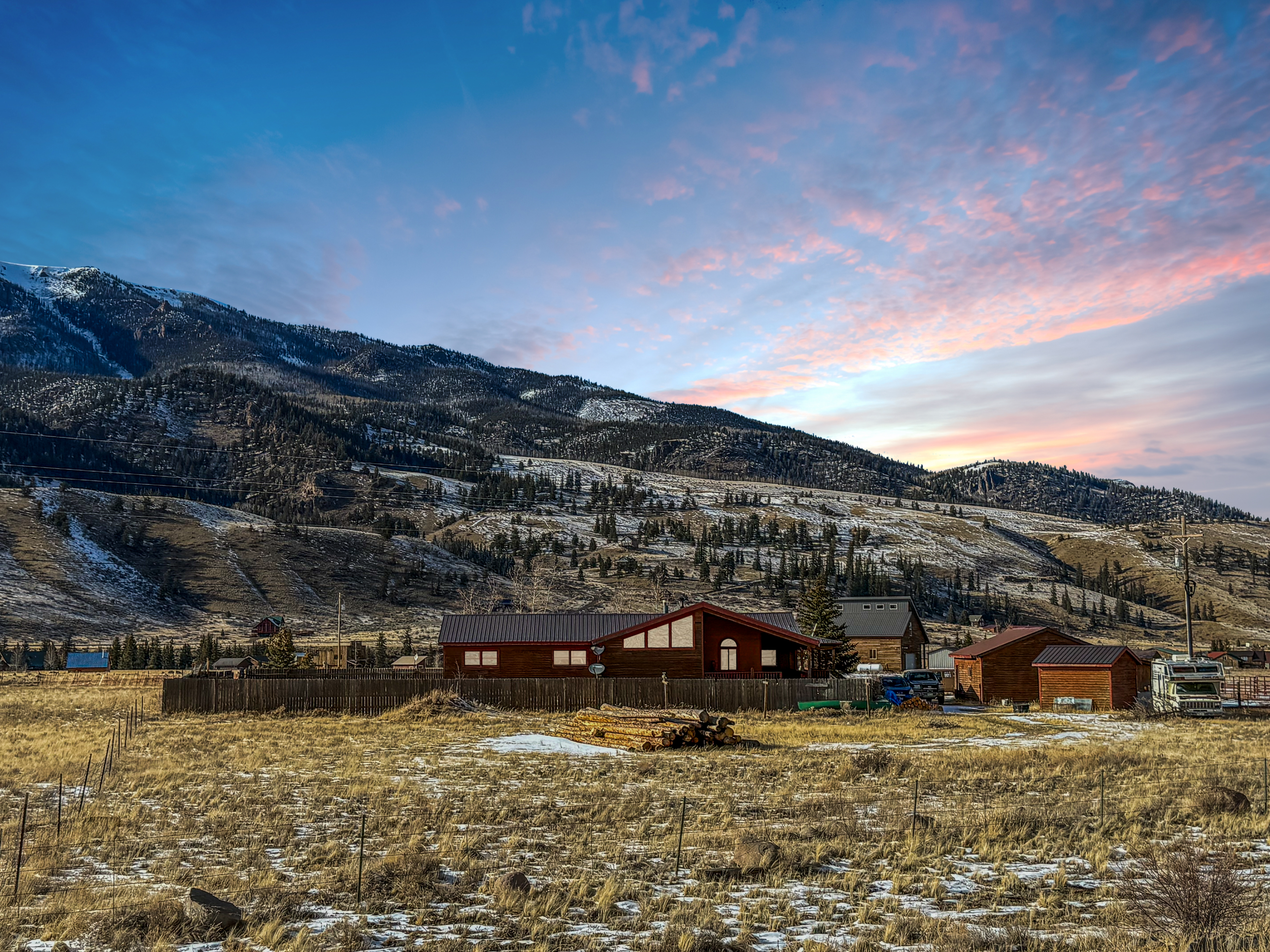 A mountain home beneath a sunset sky