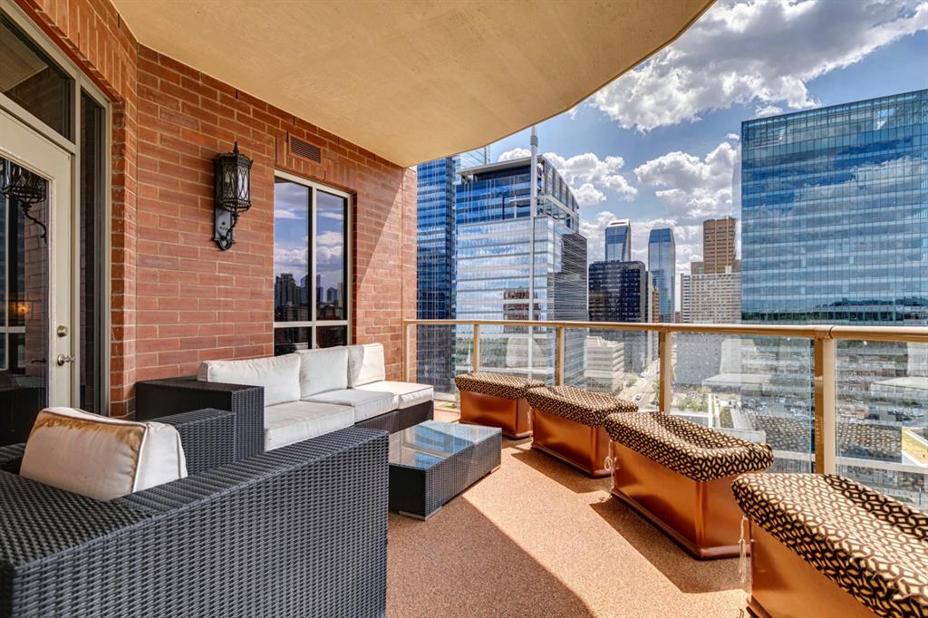 Balcony of a Calgary condominium with outdoor seating and skyline view illustrating condo living lifestyle