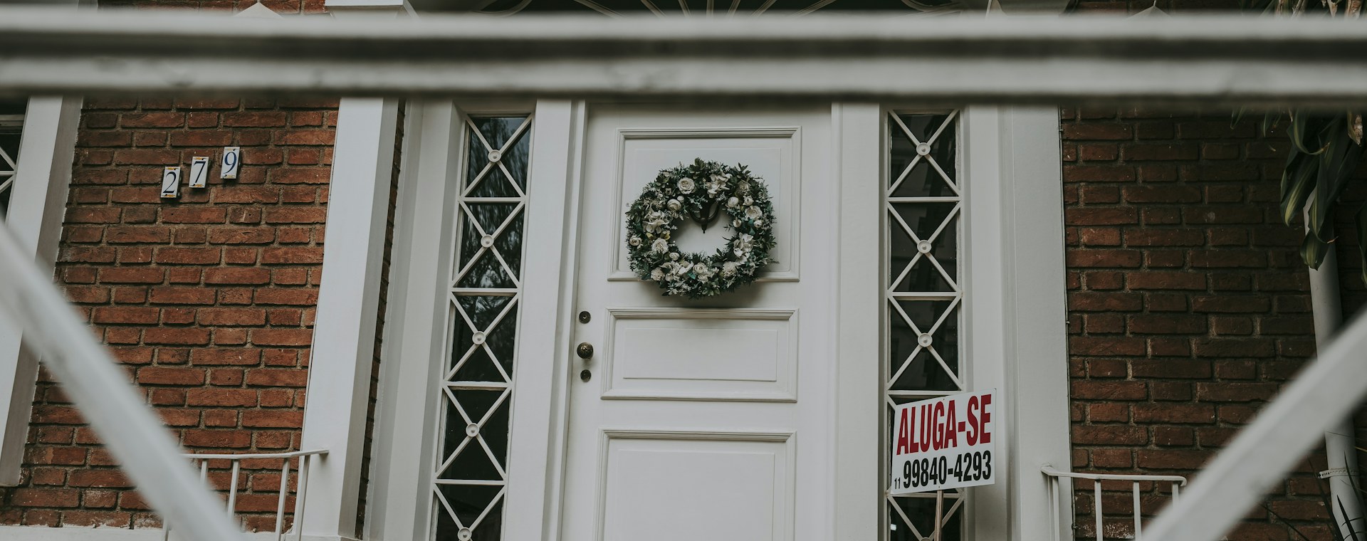 A front door with a wreath, the entrance to a home