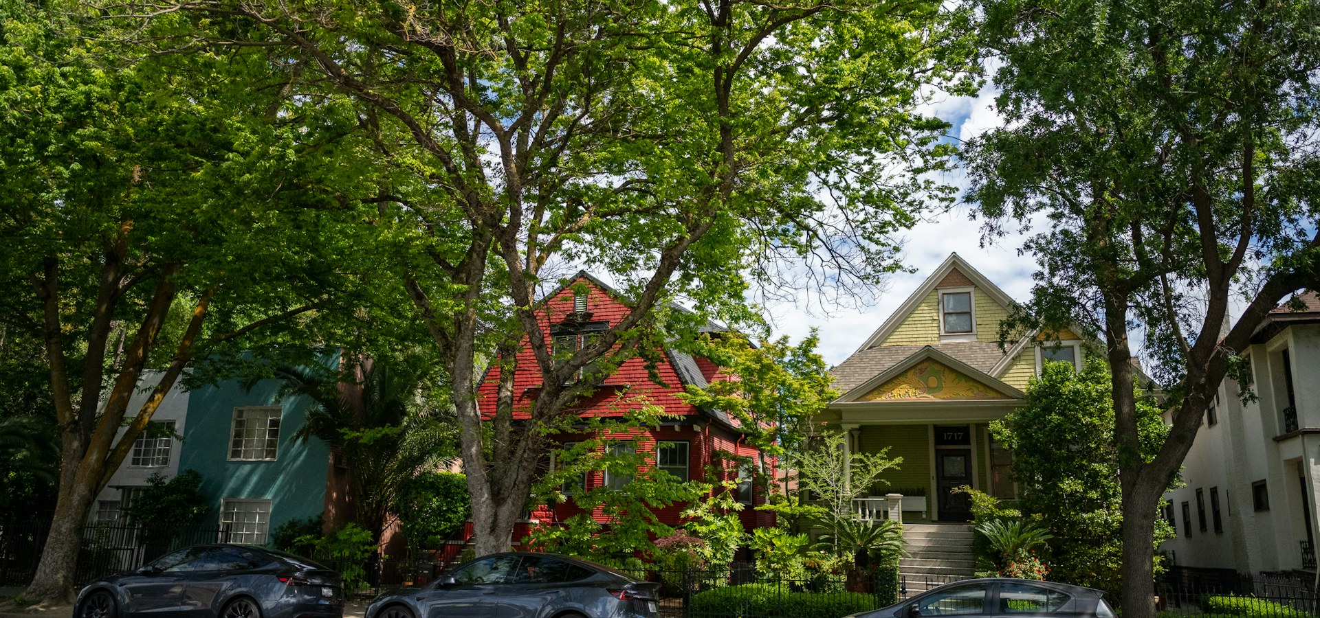 Colorful painted houses along a tree-lined street in Midtown Sacramento