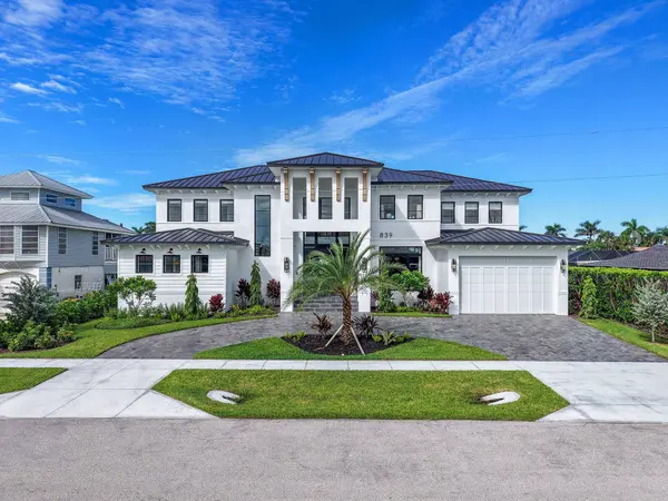 Marco Island brand new luxury waterfront estate with modern coastal architecture, metal roof, and two-car garage