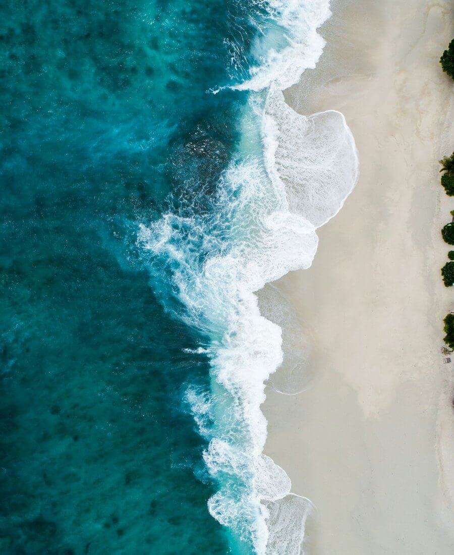 Clear turquoise Gulf water meeting white quartz sand on a Sarasota barrier island beach