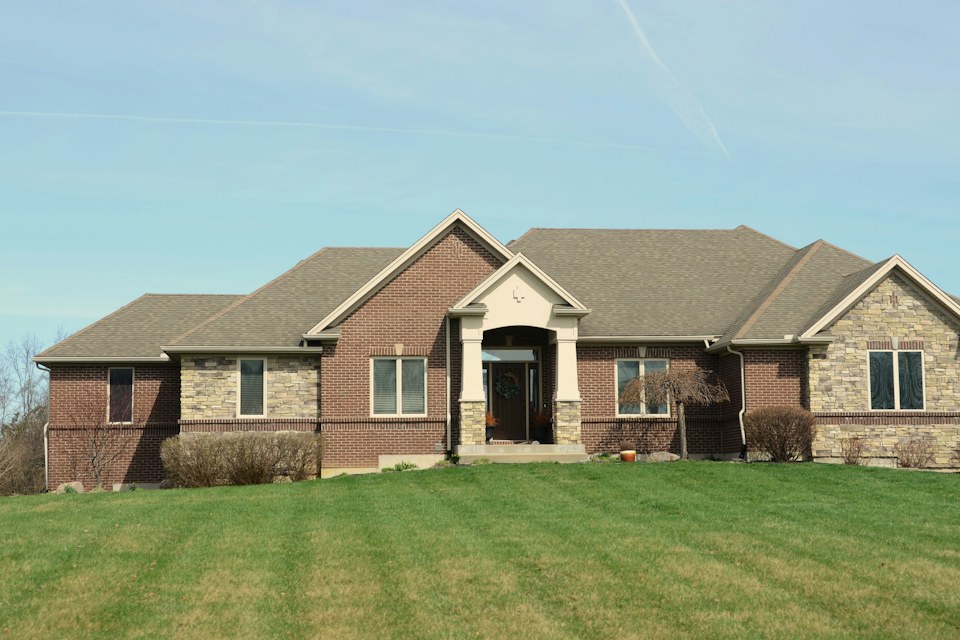 Brick home with a manicured front lawn