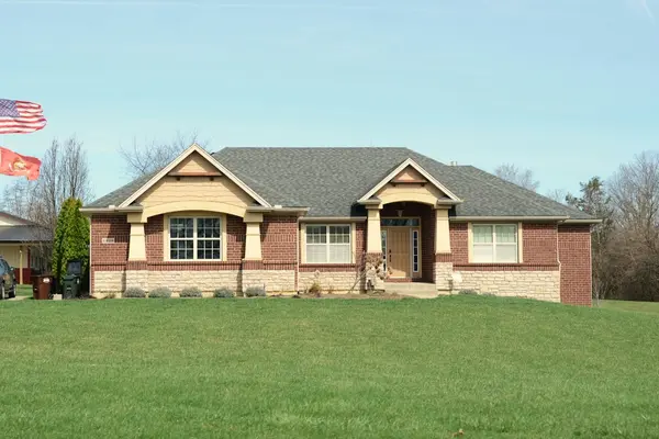 A brick home with a large green front lawn in a Central Arkansas neighborhood