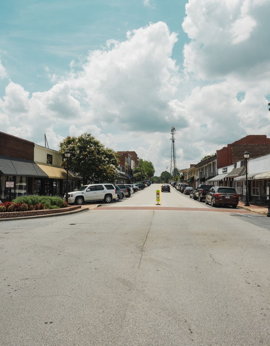 Historic downtown buildings and parked cars along a small-town street