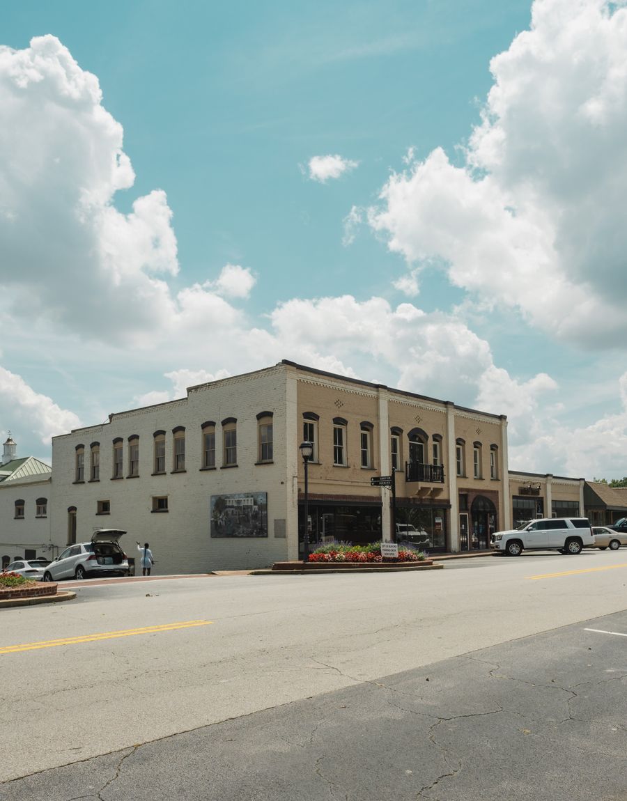 A historic brick building on a sunny downtown main street