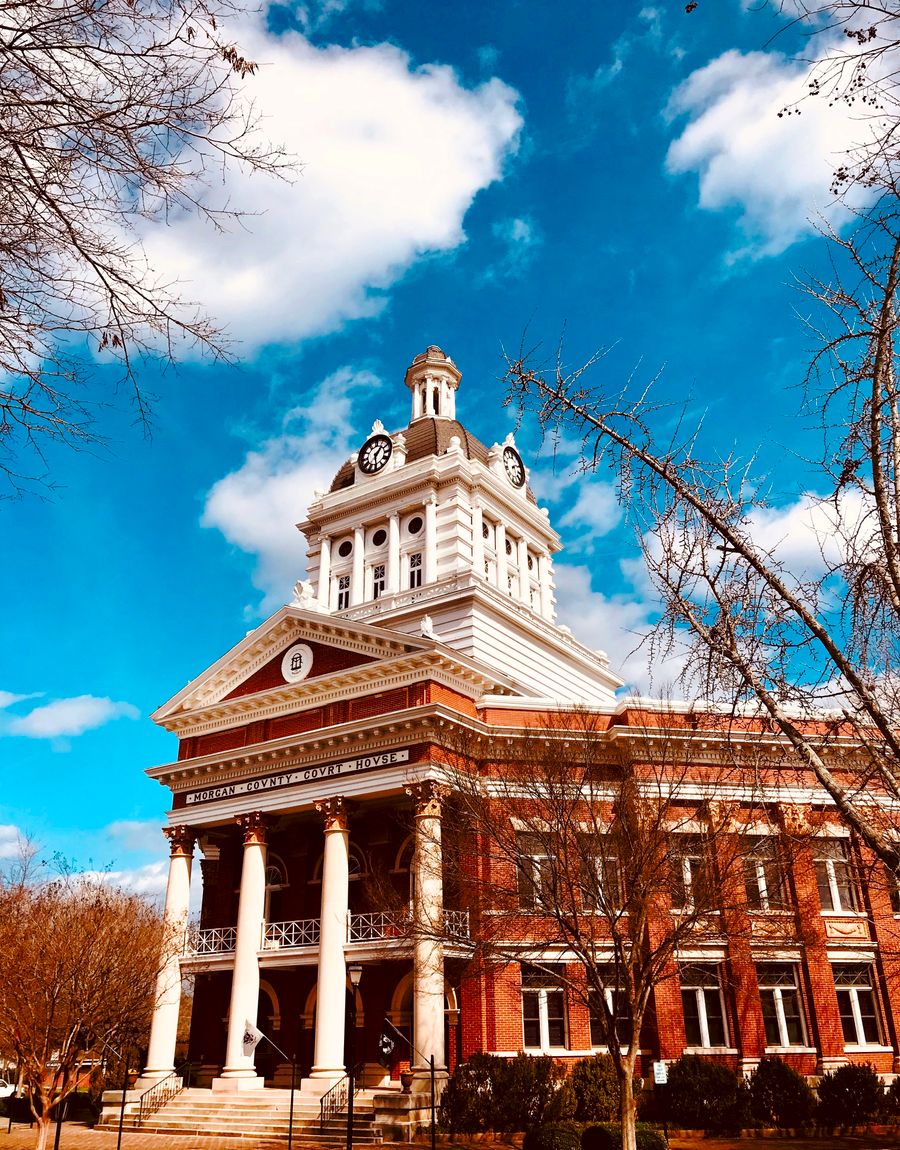 A historic courthouse with a tower against a bright blue sky