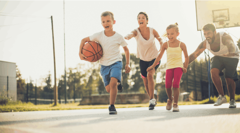 Family playing basketball outside