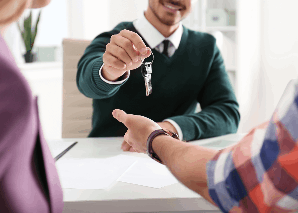 Real estate closing with keys and signed contracts