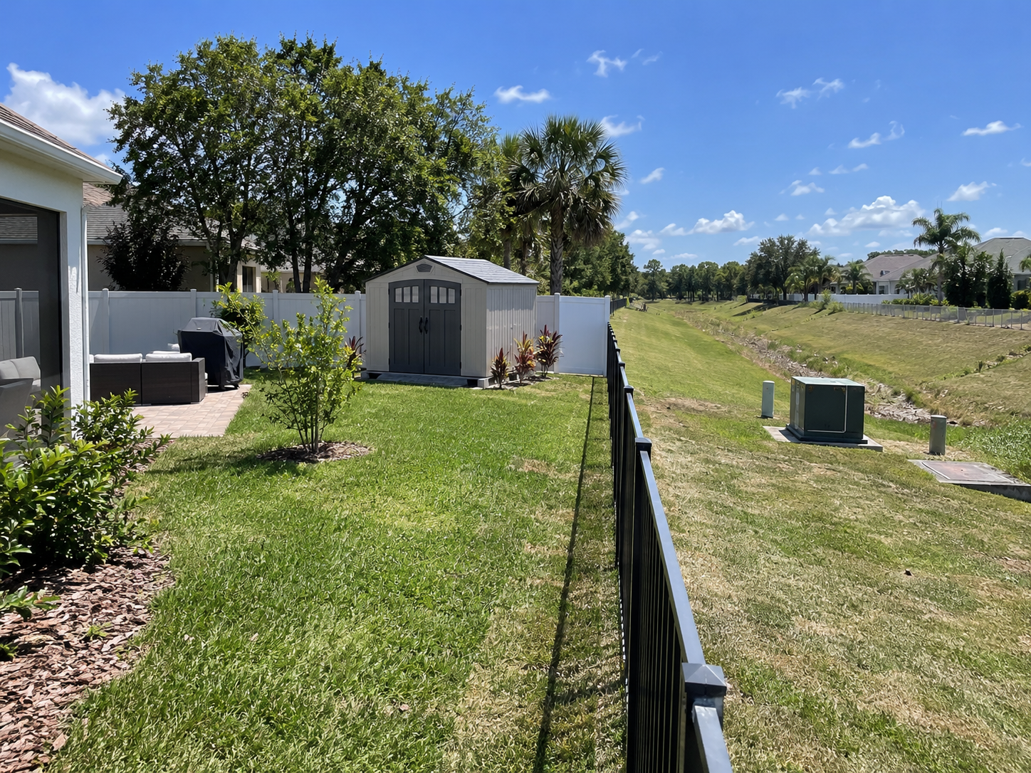 Orlando backyard with fence shed and utility easement area