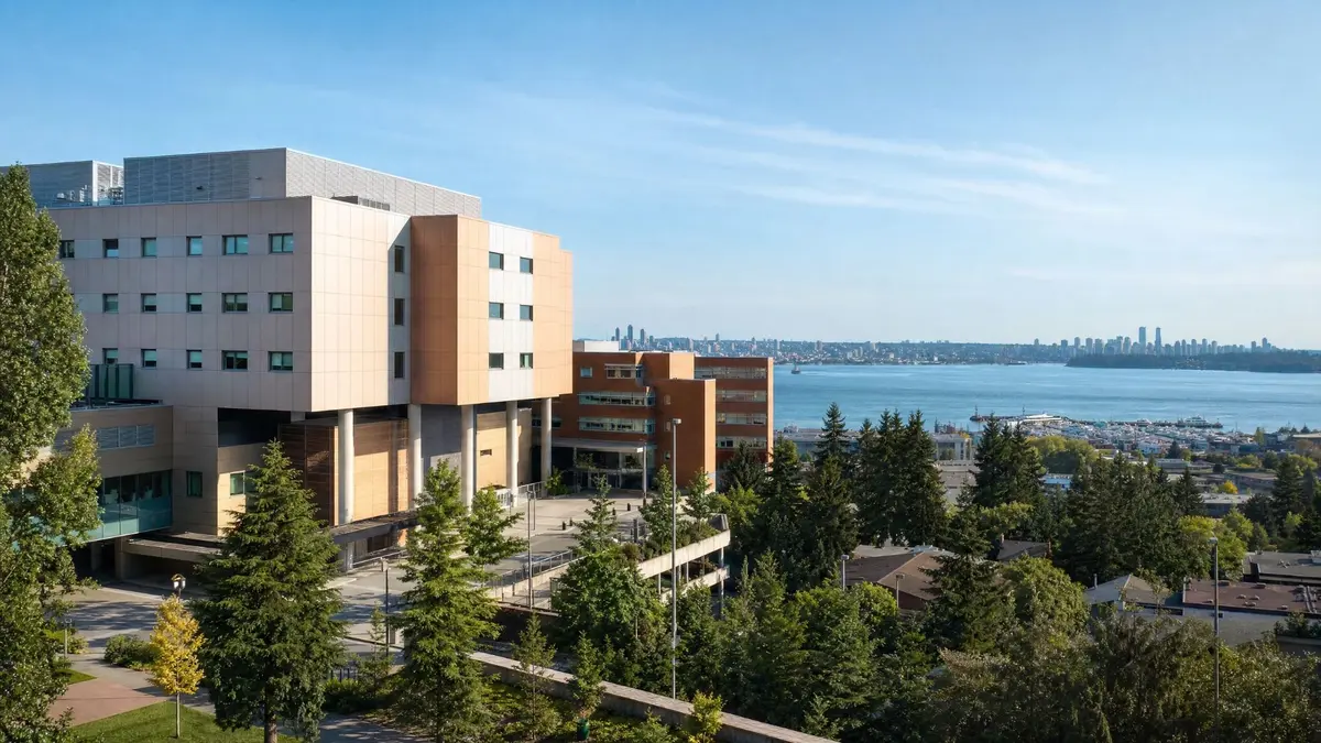 Lions Gate Hospital in North Vancouver with views toward Burrard Inlet and the Vancouver skyline.