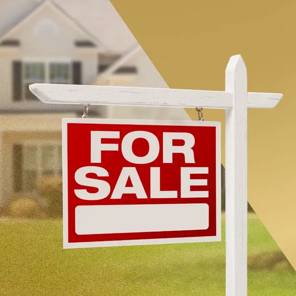 Red for sale sign in front of a residential home, representing selling a house in today’s real estate market.