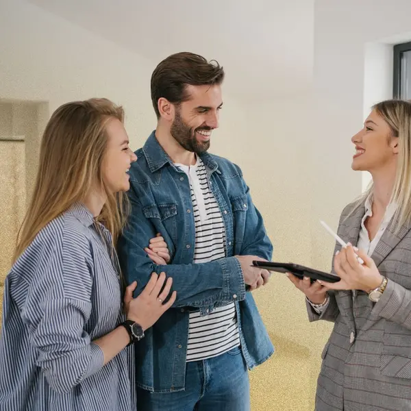 Smiling couple meeting with a real estate agent