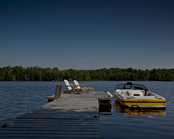 yellow boat docked at a pier