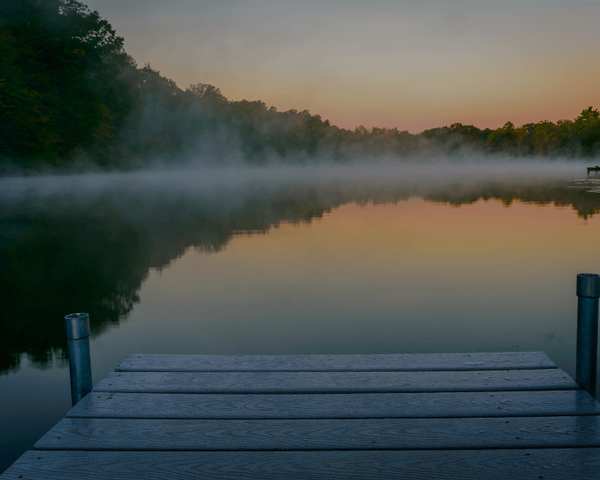 Lake with fog rising on the water