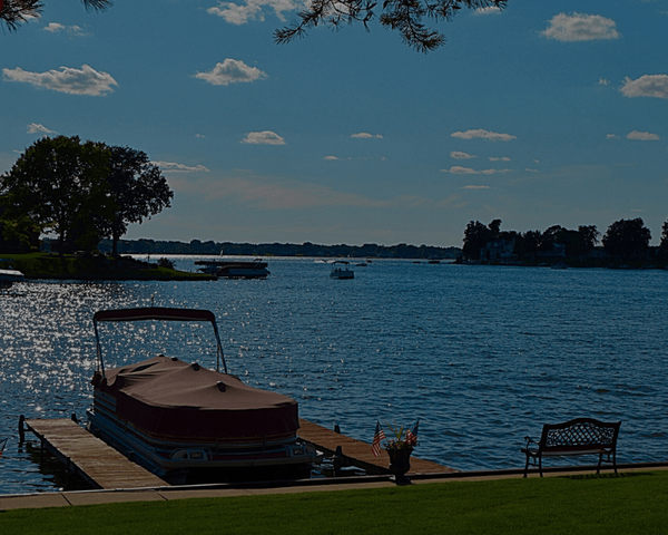 covered pontoon boat at a pier