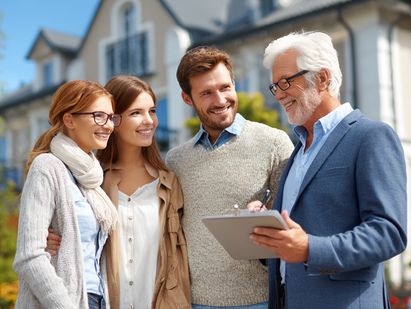Male Realtor with home buyers