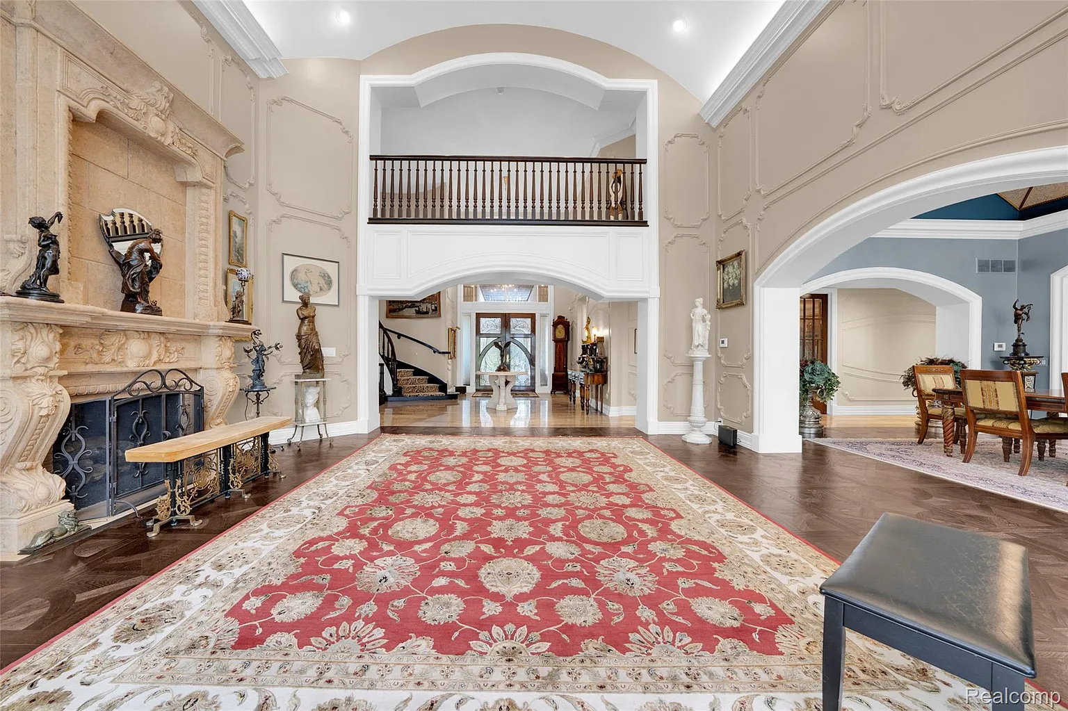 Custom Gothic Tudor living room with double-sided fireplace in Brighton MI luxury home
