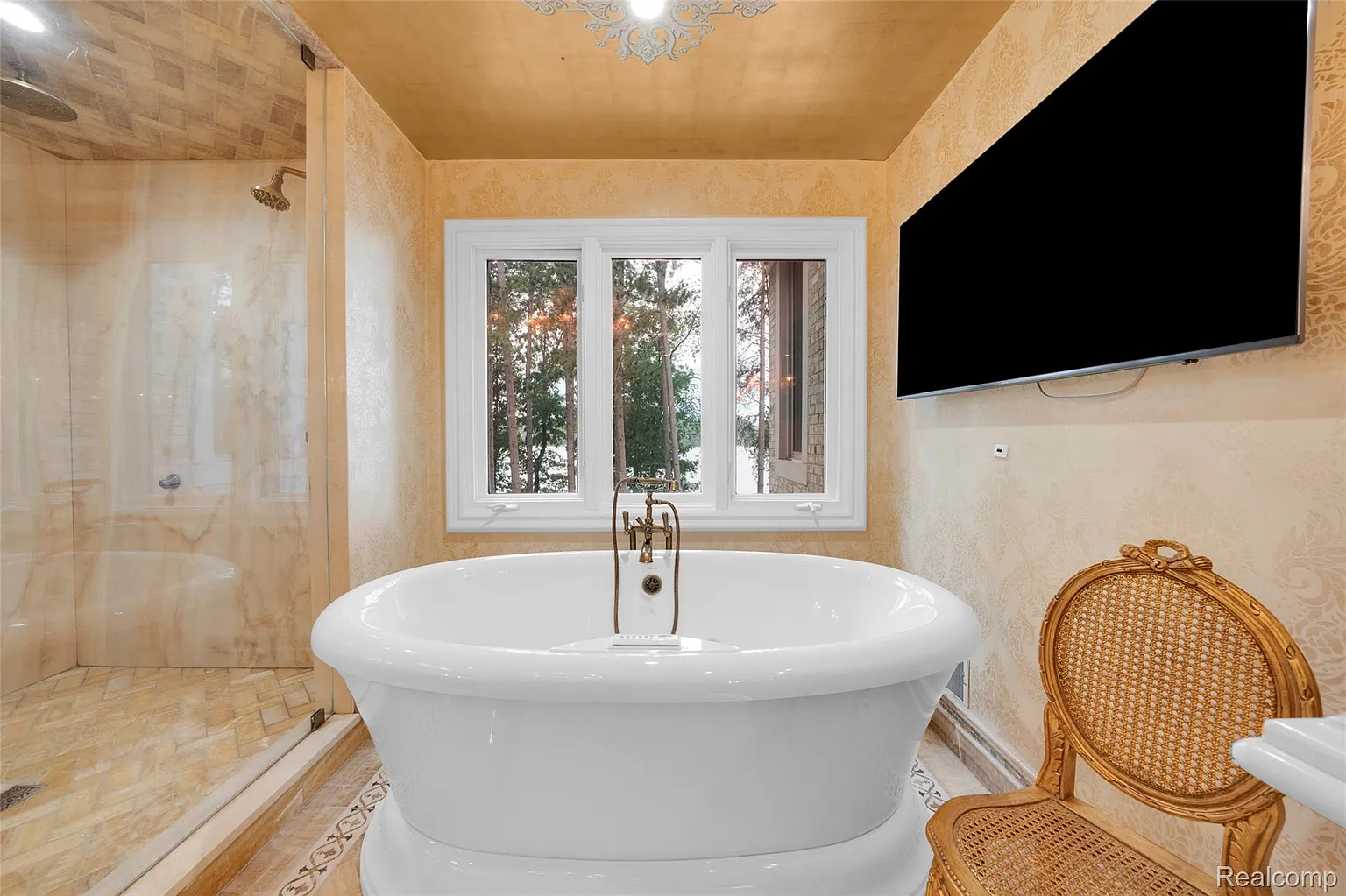 Luxury primary suite spa bathroom with soaking tub and lake views Brighton MI