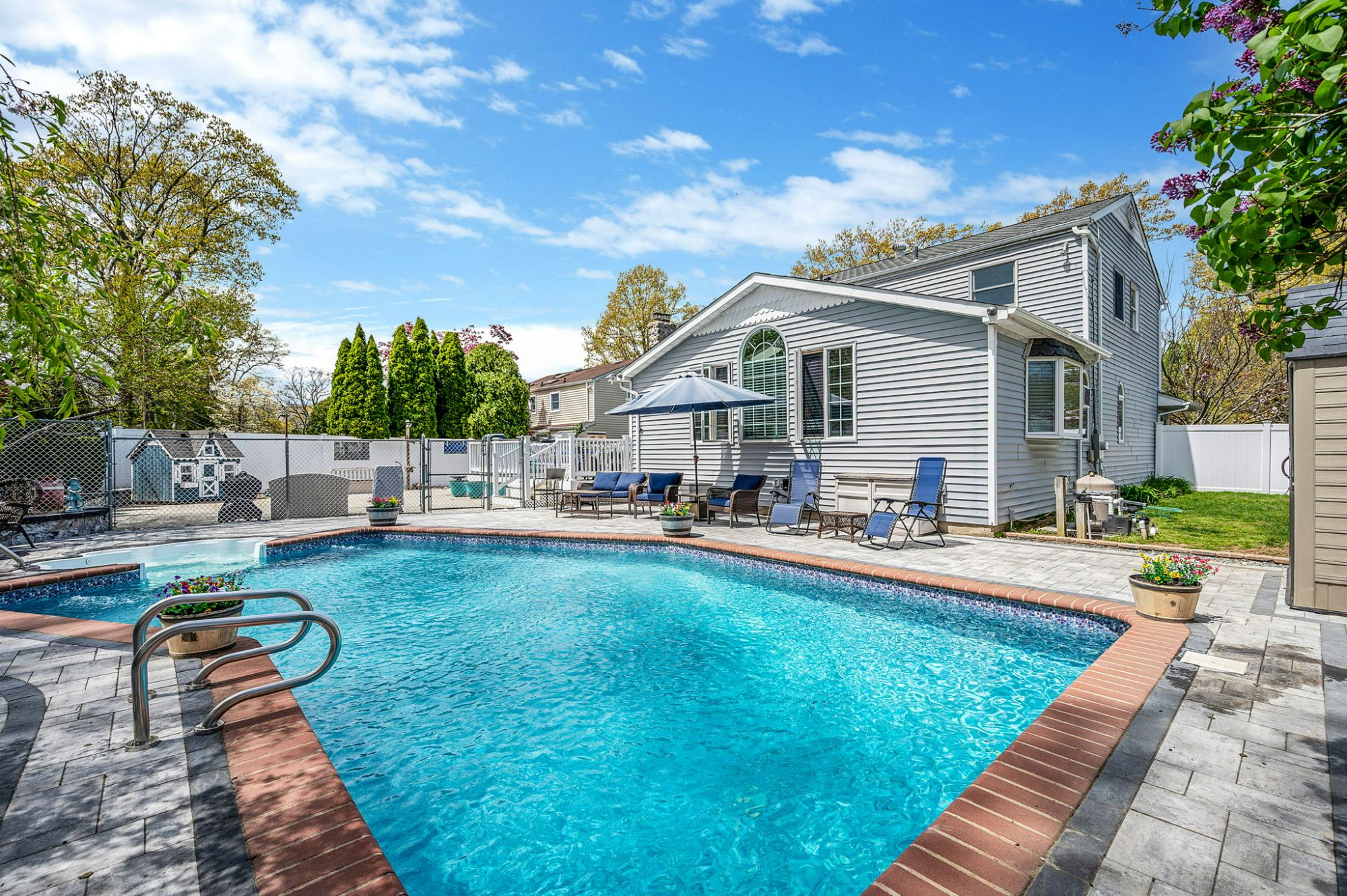 Professionally photographed Long Island home with backyard and swimming pool