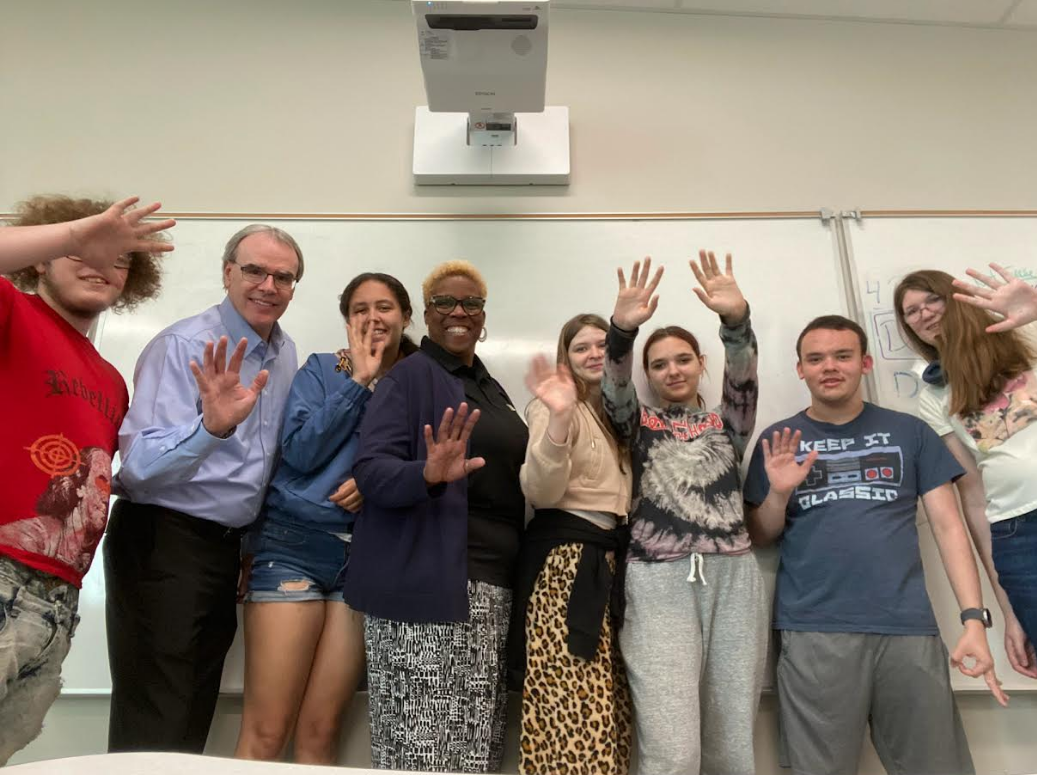 David Campbell, Realtor, stands beside six students and their teacher Ms. Wade while visiting Fairborn High School.