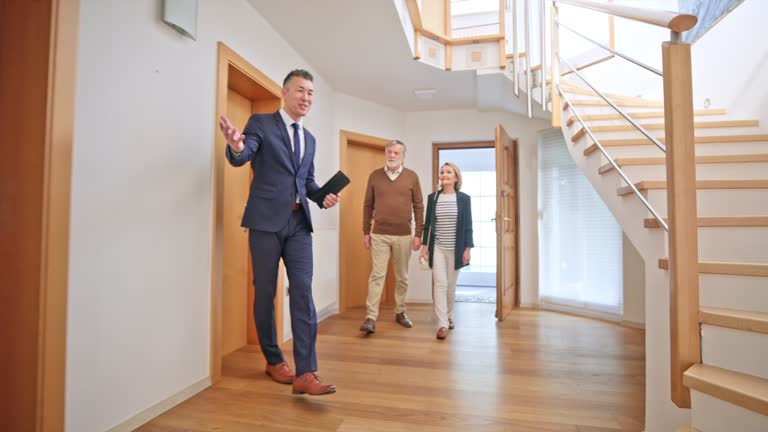 Real Estate agent conducting a home tour for a couple.