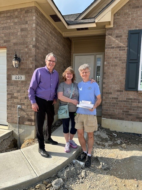 David and Sandy in front of their new home build in Centerville, Ohio with David Campbell, realtor.