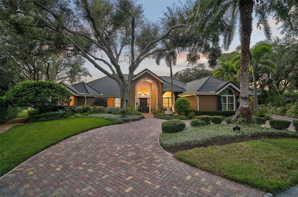 Front exterior of 662 Fernwalk Ln in The Oaks Club Bayside Osprey FL