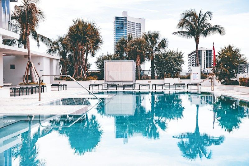 Resort style community pool and palms, the kind of amenity the Royal Palm Polo Residents Club covers