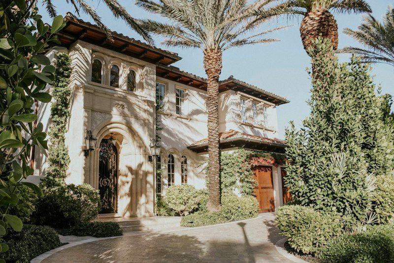 Mediterranean style Boca Raton home with barrel tile roof and date palms