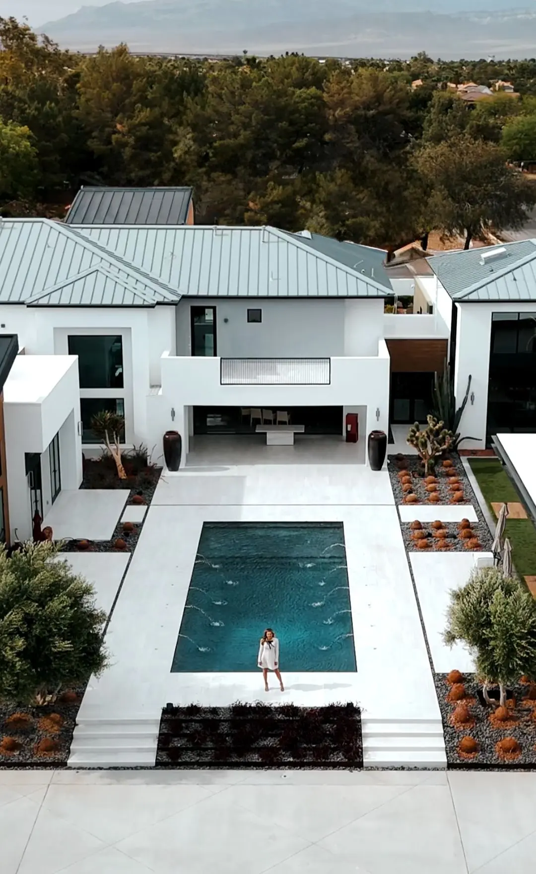 Aerial photo of Las Vegas luxury listing agent Ina Medina in the backyard of a high-end home, showcasing her role as a strategic marketing expert and real estate broker.