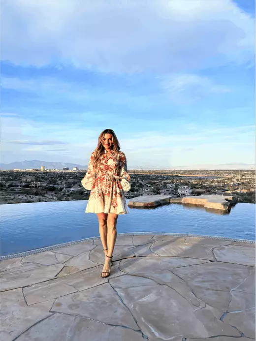 Ina Medina, Las Vegas Real Estate Broker-Salesperson, by the infinity pool of a $24M Simply Vegas listing, overlooking panoramic Strip and city skyline views — featured in the award-winning, client-focused section of the About page.