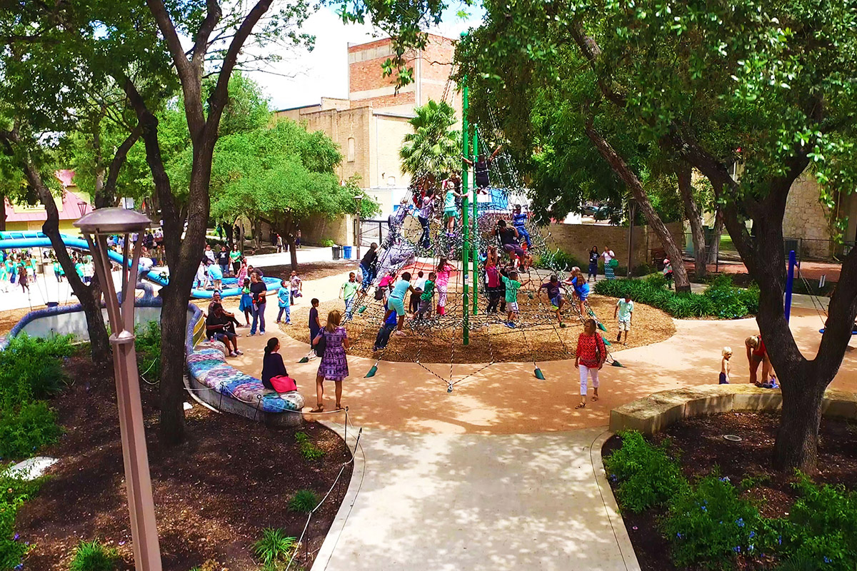 Families with children enjoying playground at San Antonio neighborhood park