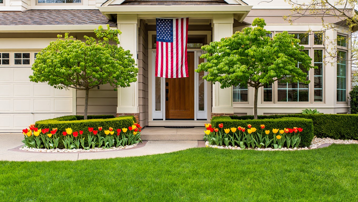 Clean front yard with American flag and neat landscaping