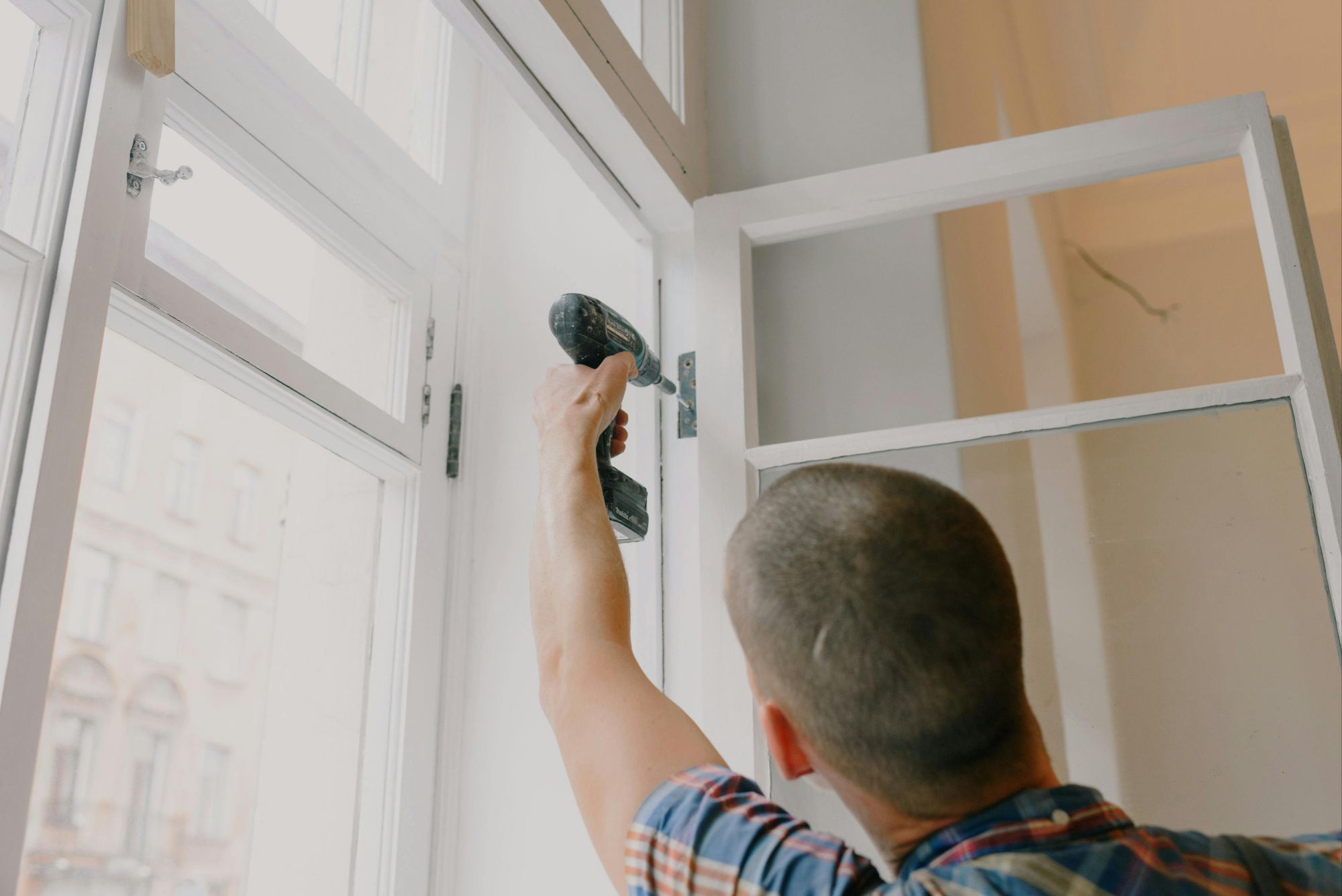 Handyman installing windows in the room