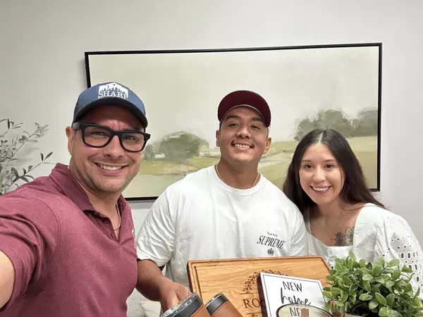 Anthony Sharp from Sharp Realty Group with satisfied clients Jesse R and his partner, smiling after a successful home purchase San Antonio