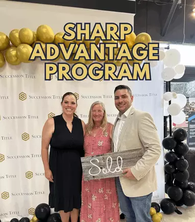 Anthony Sharp and two sellers pose beneath gold balloons at Succession Title with a rustic ‘Sold’ sign