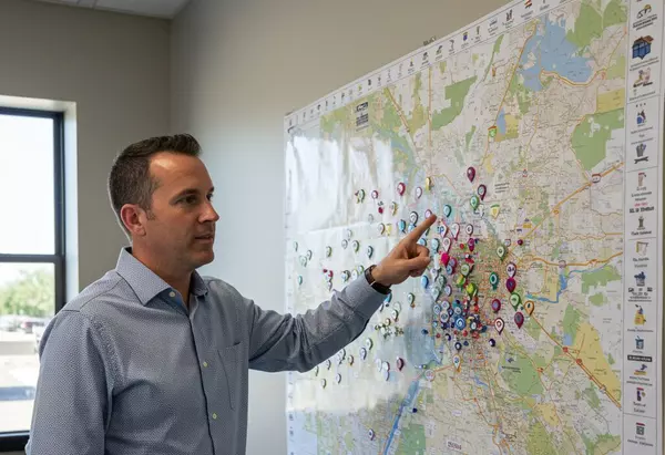 Military relocation specialist reviewing San Antonio neighborhood map for Randolph AFB PCS planning