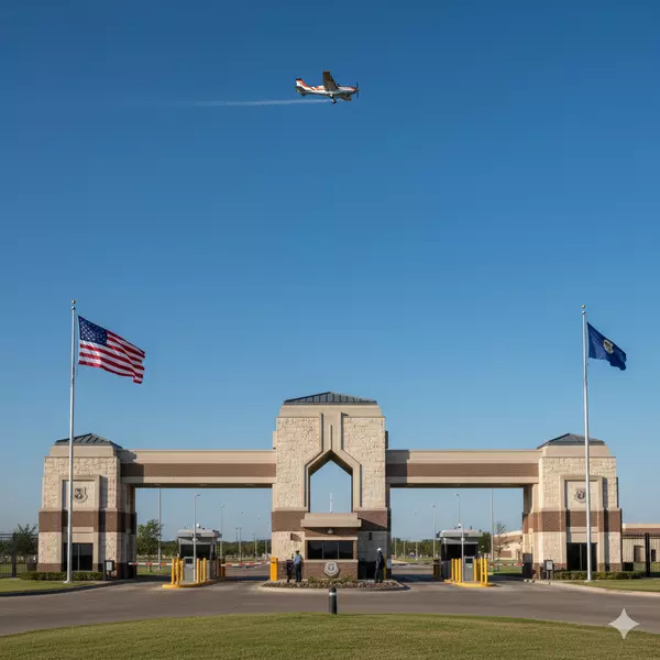 Randolph Air Force Base main gate entrance with T-6 training aircraft overhead - JBSA military installation San Antonio