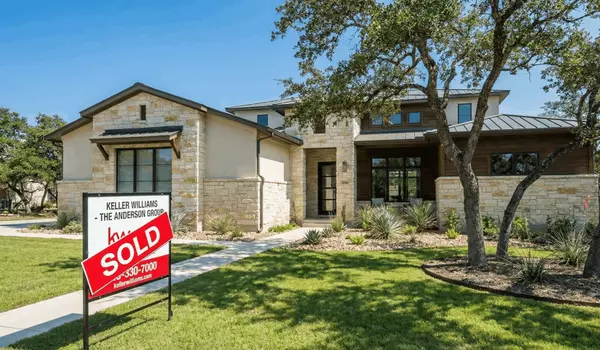 modern stone oak home with a sold sign illustrating strong market demand