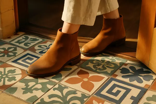 Stylish Boots on Mosaic Tile